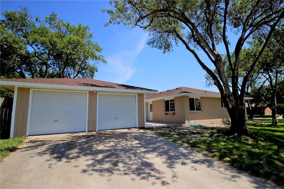 4202 Nicklaus Lane Corpus Christi, TX 78413 - Photo 6 of 8 a white house that has a tree in front of it