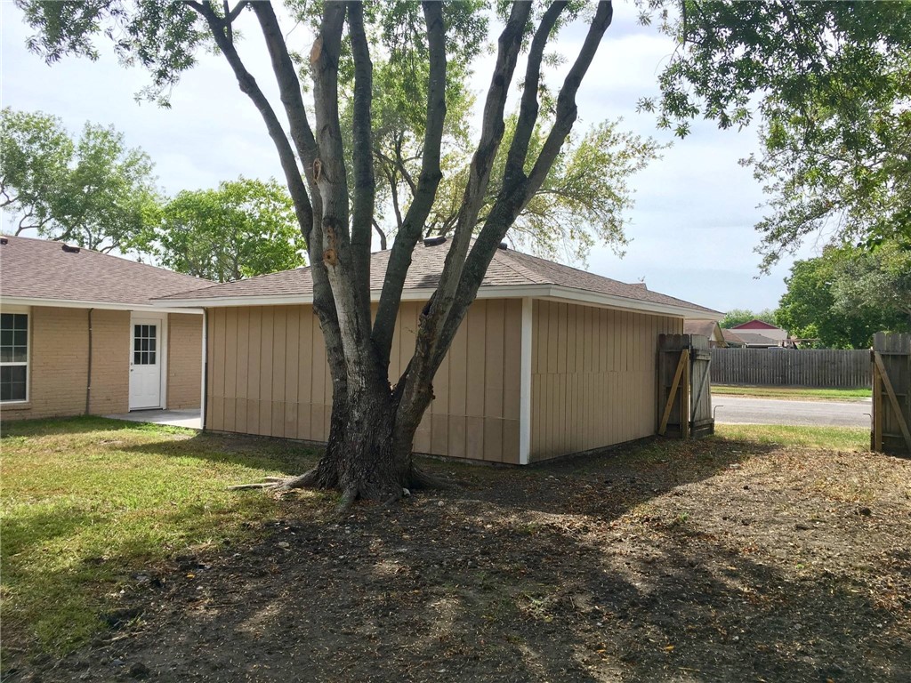 4202 Nicklaus Lane Corpus Christi, TX 78413 - Photo 7 of 8 a view of a house with backyard and a tree