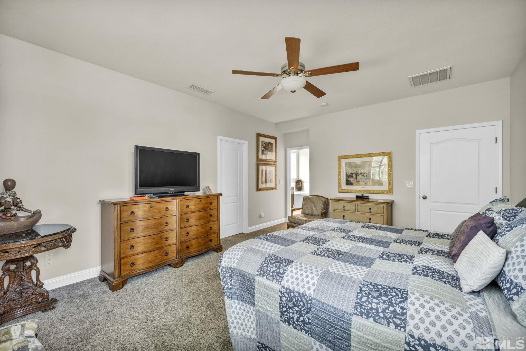 2199 Angel Ridge Drive Reno, NV 89521 - Photo 17 of 36 a bedroom with a bed and flat screen tv