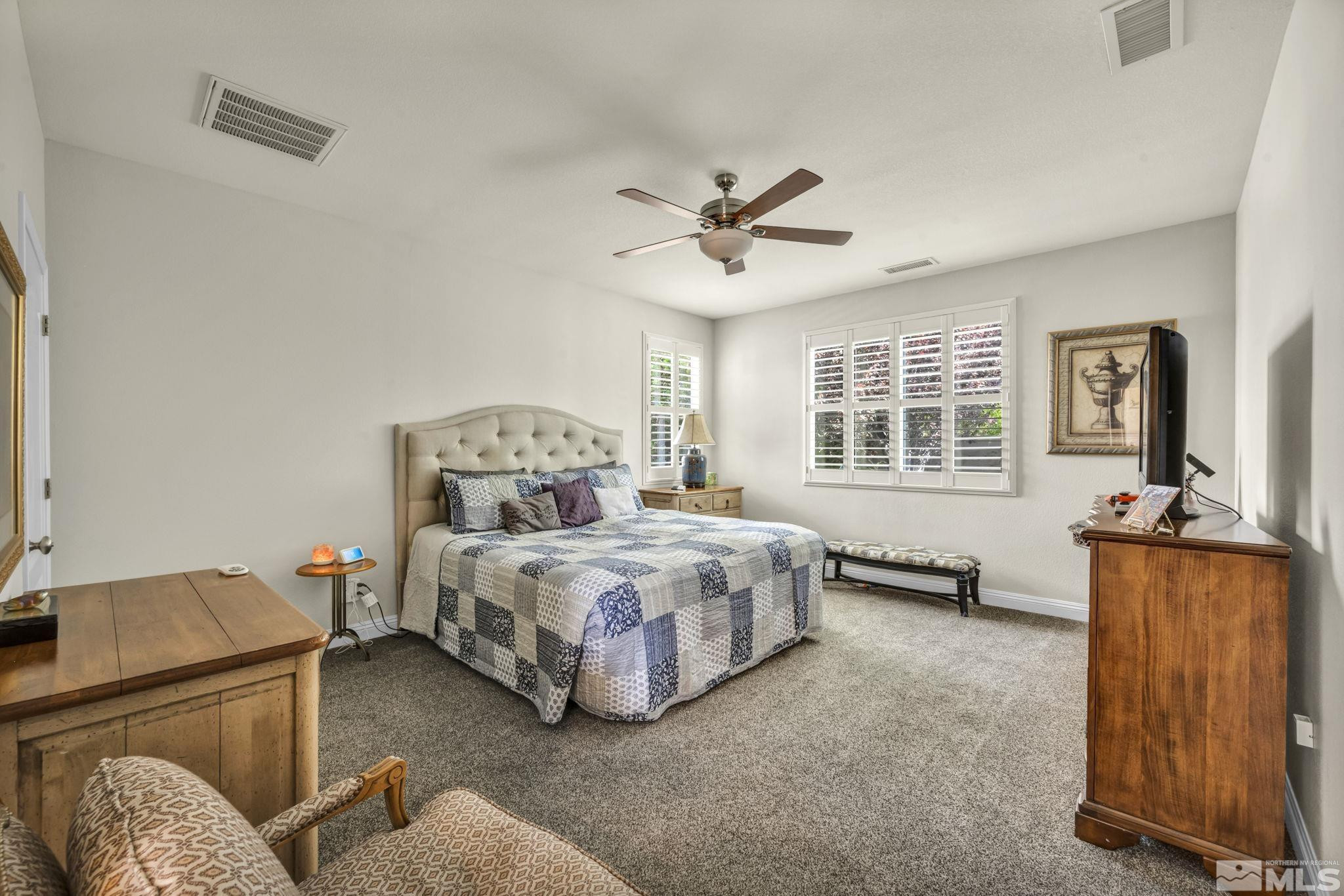 2199 Angel Ridge Drive Reno, NV 89521 - Photo 18 of 36 a bedroom with a bed couch and window