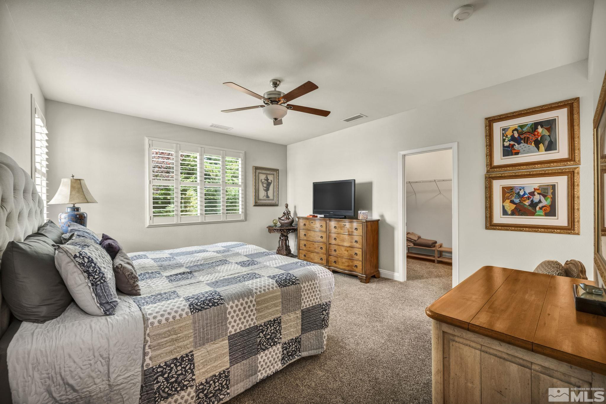 2199 Angel Ridge Drive Reno, NV 89521 - Photo 19 of 36 a bedroom with a bed and a flat screen tv