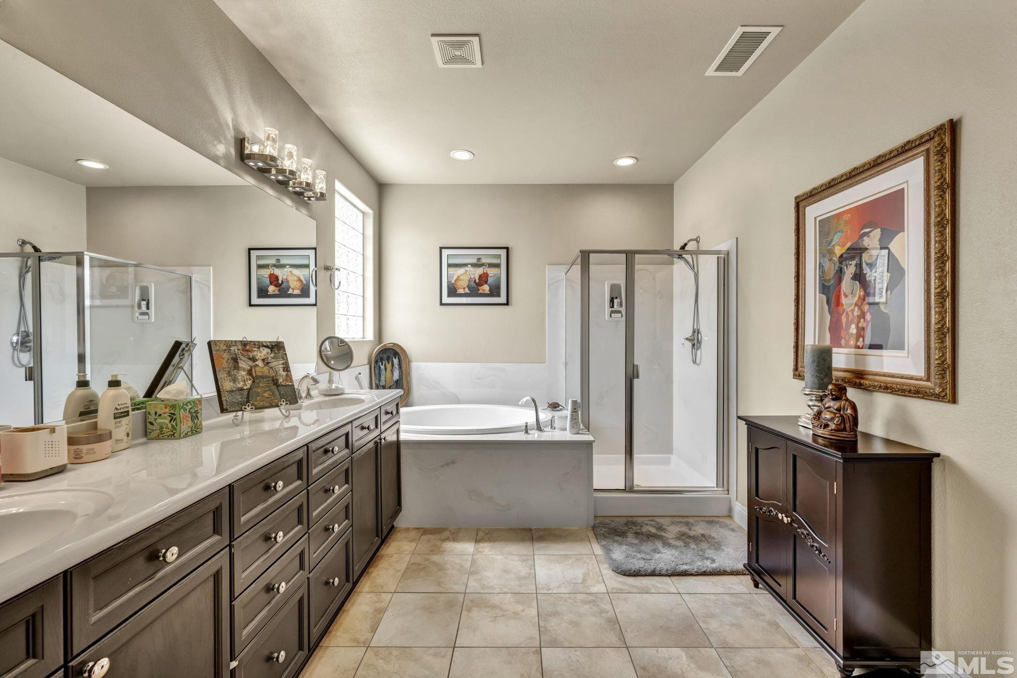 2199 Angel Ridge Drive Reno, NV 89521 - Photo 21 of 36 a spacious bathroom with a double vanity sink a mirror and a shower