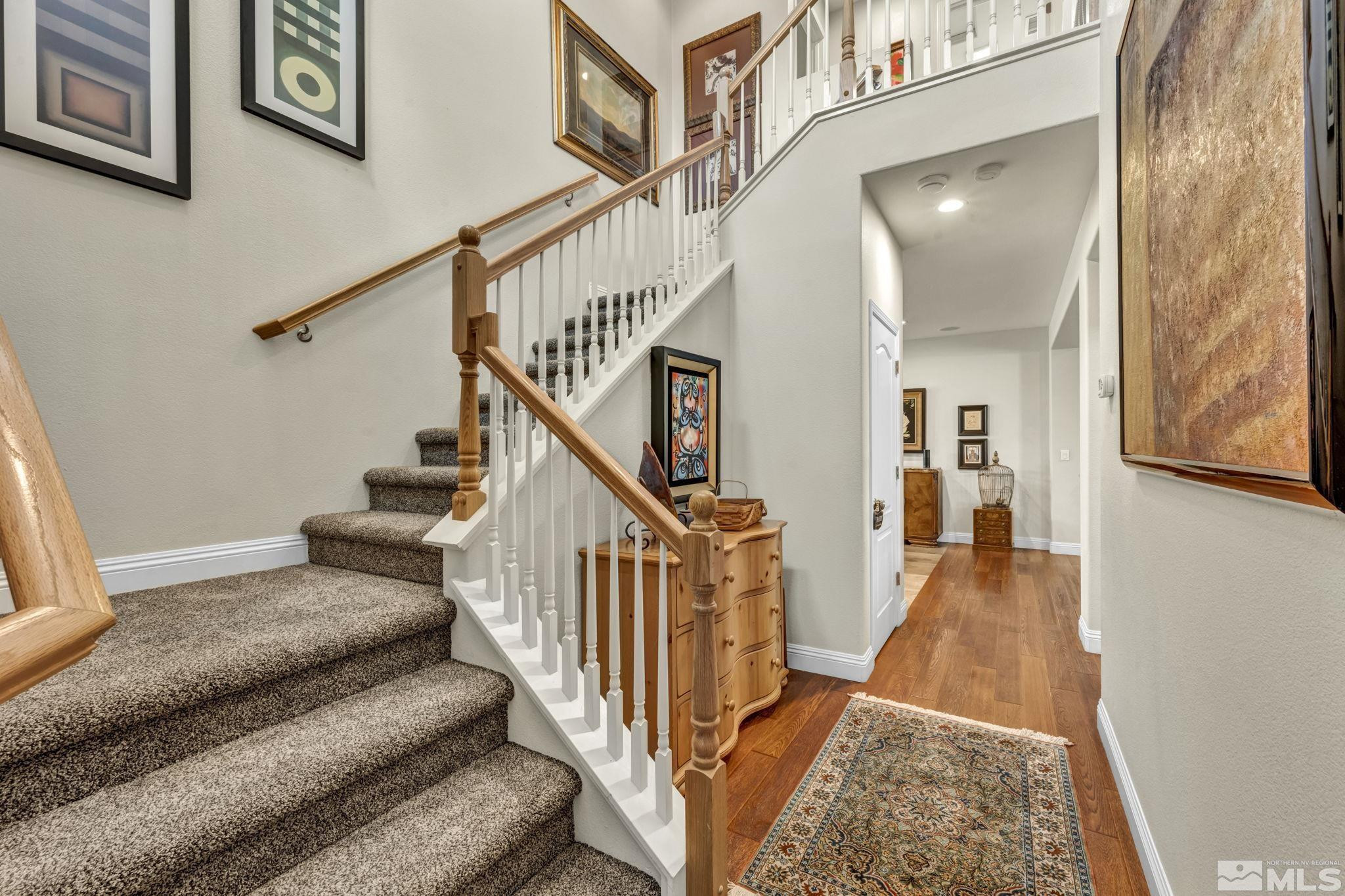 2199 Angel Ridge Drive Reno, NV 89521 - Photo 23 of 36 a view of staircase with lots of frames on wall and a dining table