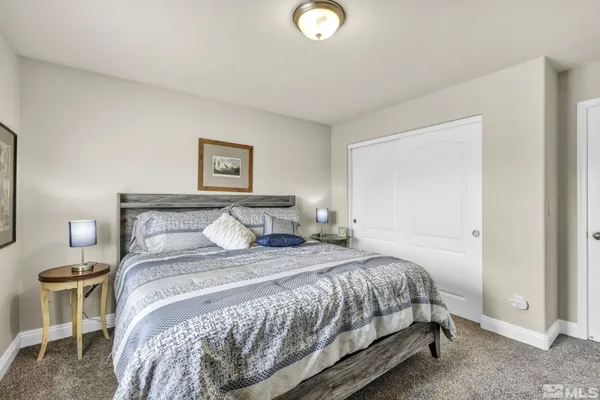 a bedroom with a bed and a lamp