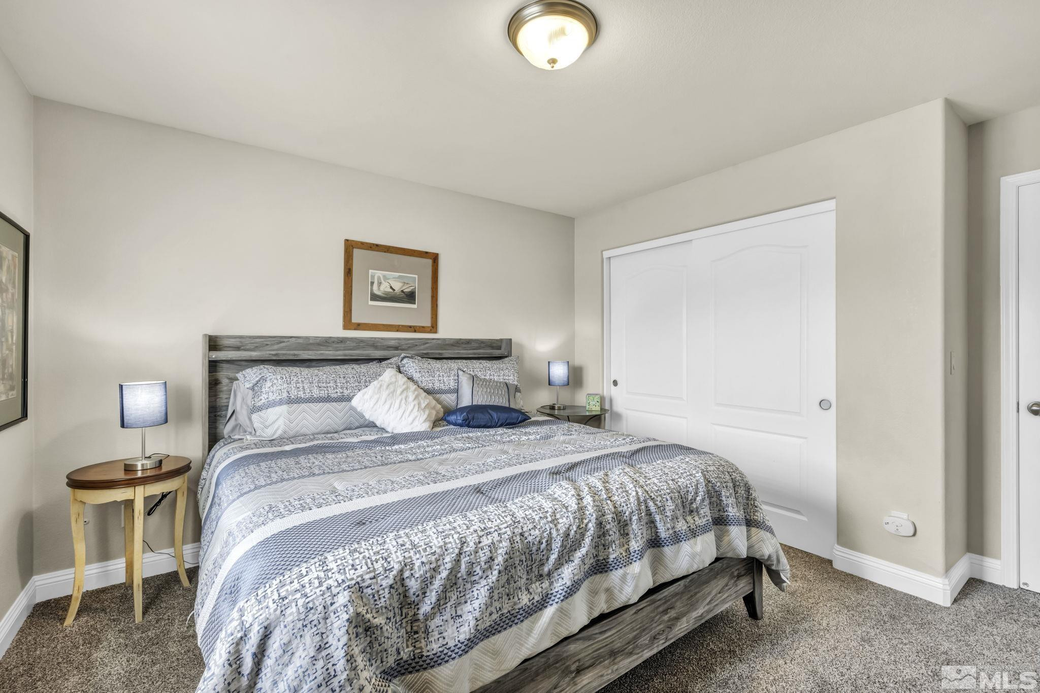 2199 Angel Ridge Drive Reno, NV 89521 - Photo 25 of 36 a bedroom with a bed and a lamp