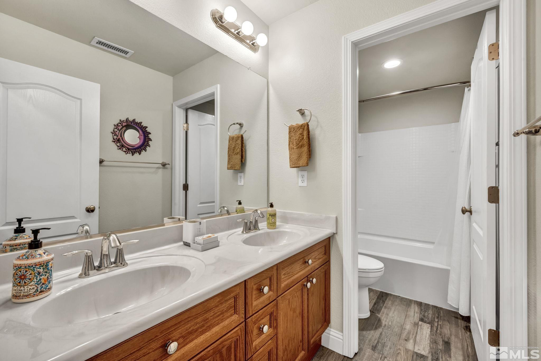 2199 Angel Ridge Drive Reno, NV 89521 - Photo 28 of 36 a bathroom with a granite countertop sink mirror and a bathtub