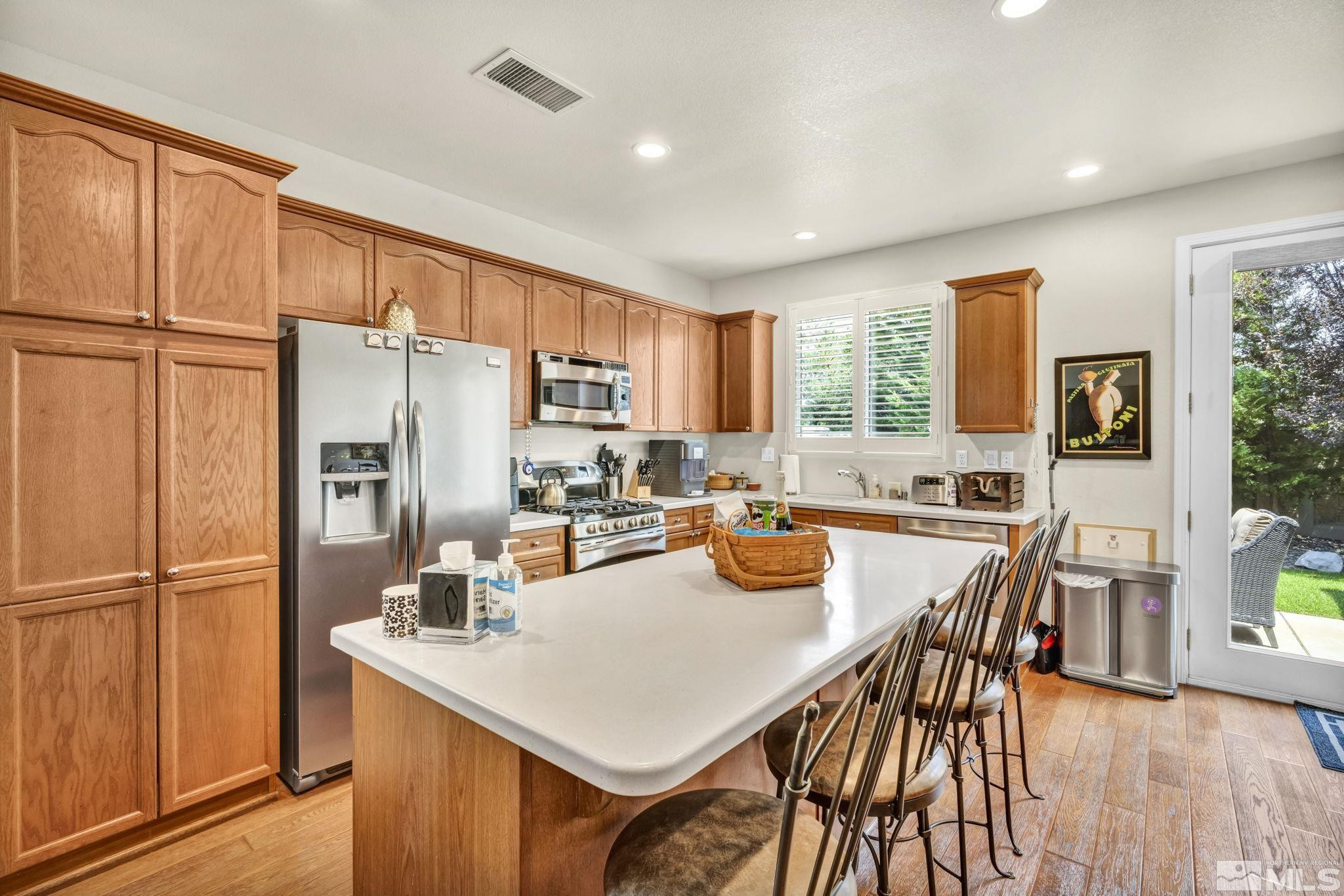 2199 Angel Ridge Drive Reno, NV 89521 - Photo 4 of 36 a kitchen with refrigerator a table and chairs