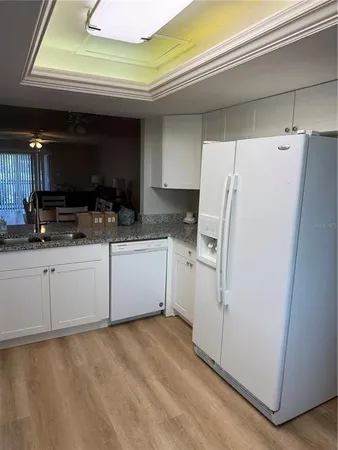 a white refrigerator freezer sitting inside of a kitchen