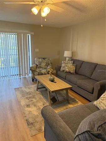 a living room with furniture and a rug