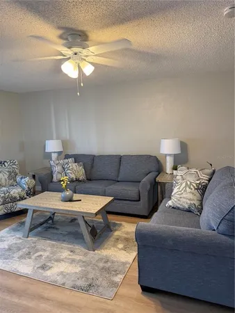a living room with furniture and a chandelier
