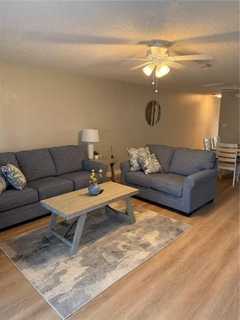 a living room with furniture and a lamp