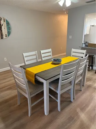 a view of a dining room with furniture and wooden floor
