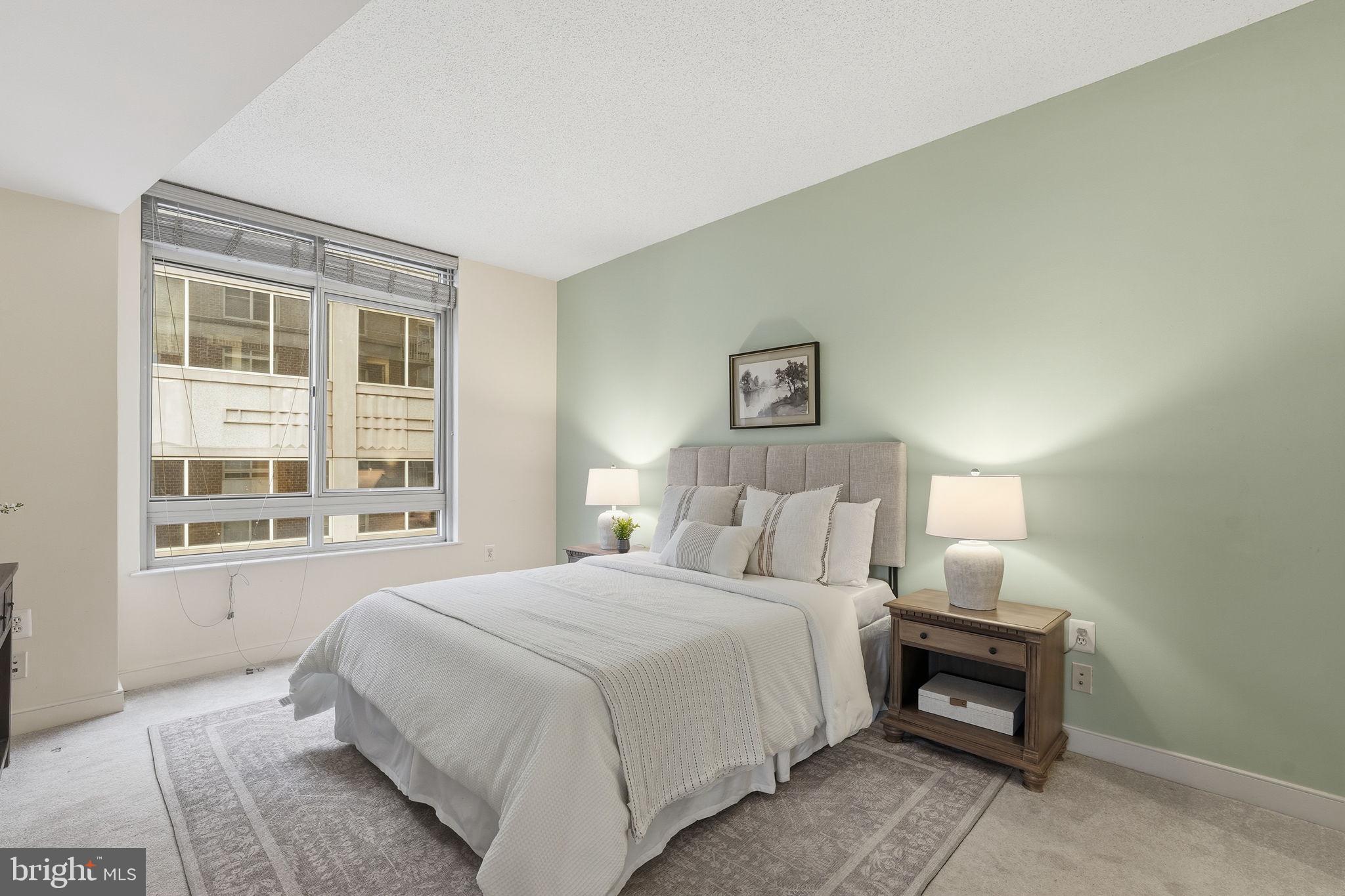 820 North Pollard Street, Unit 504 Arlington, VA 22203 - Photo 12 of 27 a bedroom with a bed a table and painting