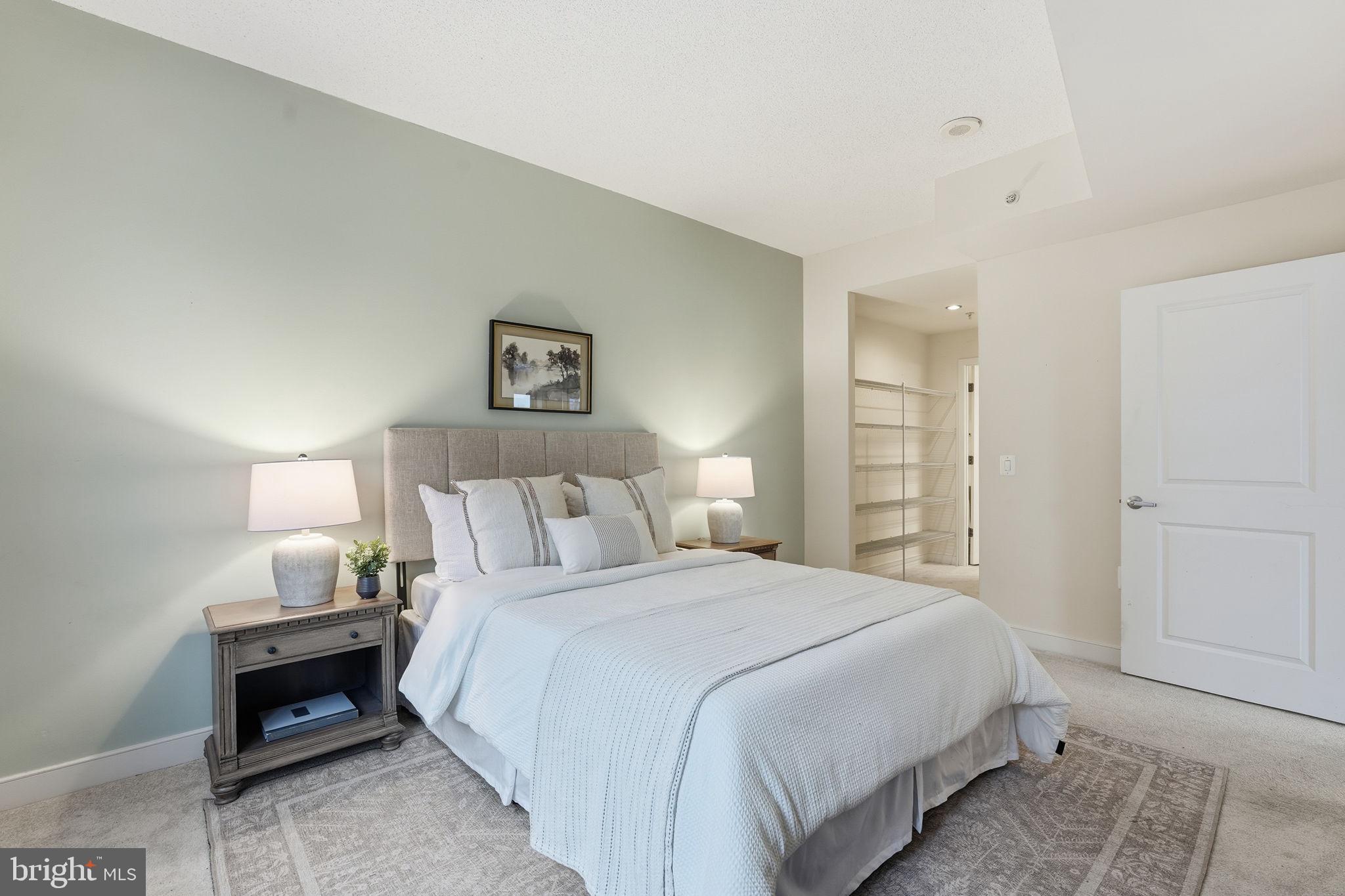 820 North Pollard Street, Unit 504 Arlington, VA 22203 - Photo 13 of 27 a bedroom with a bed and a night stand