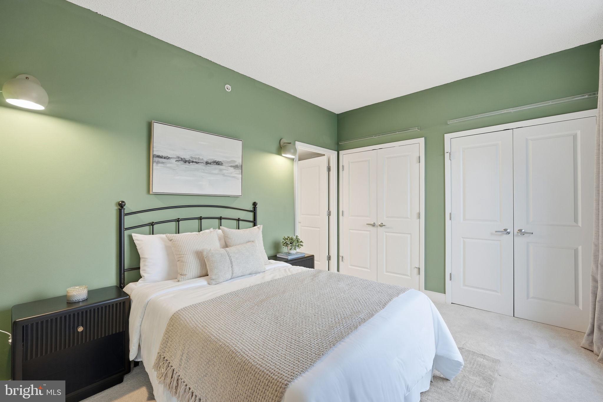 820 North Pollard Street, Unit 504 Arlington, VA 22203 - Photo 18 of 27 a bedroom with a bed and a mirror