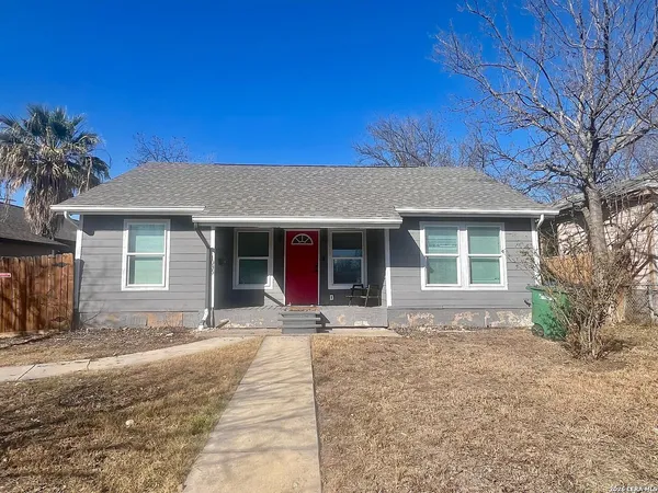 a front view of a house with a garden and yard
