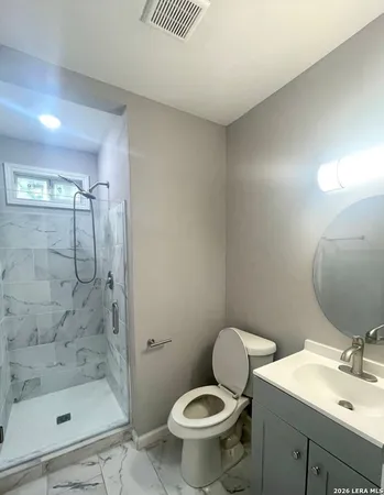 a bathroom with a sink toilet and shower