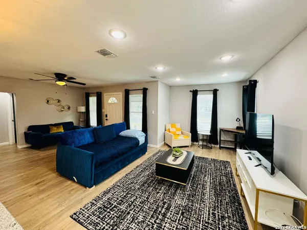 a living room with furniture and a flat screen tv