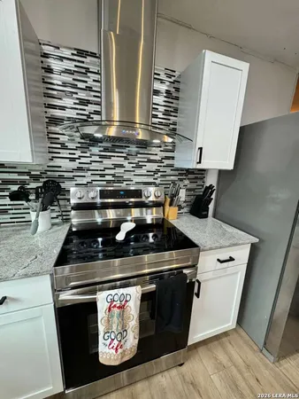 a stove top oven sitting inside of a kitchen