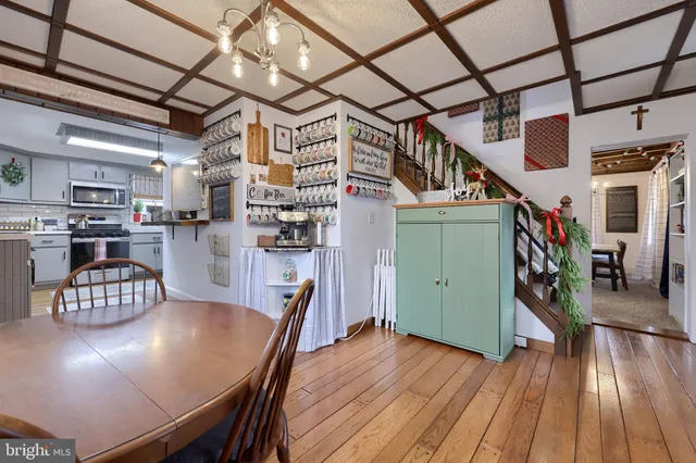 a view of a dining room with furniture wooden floor and a chandelier