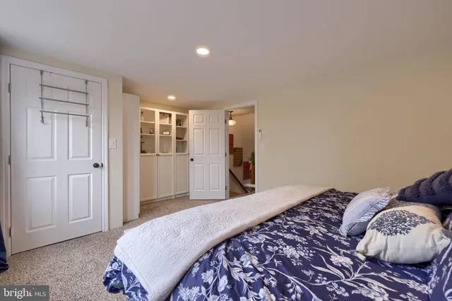 a bedroom with a bed and cabinets