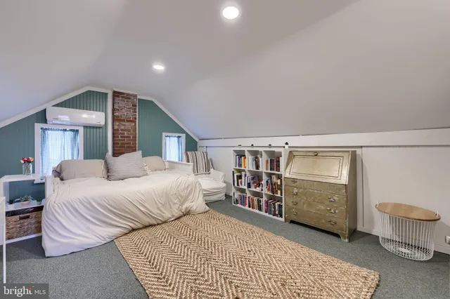 a living room with furniture a fireplace and a large window