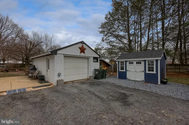 a view of a house with a large tree and a yard