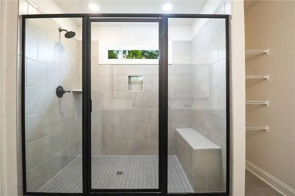 a bathroom with a glass shower door