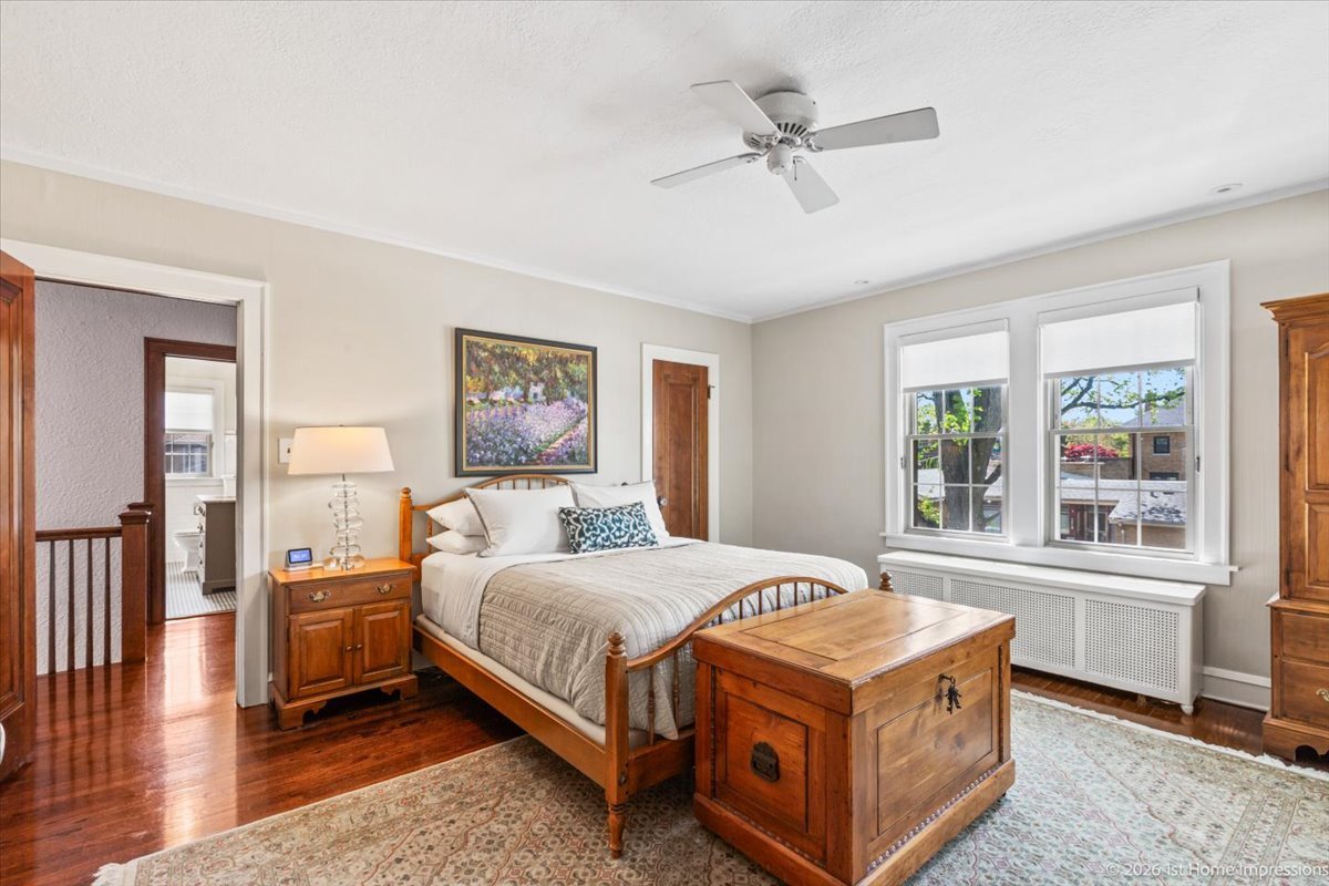 9955 South Hamilton Avenue Chicago, IL 60643 - Photo 18 of 31 a bedroom with a large bed a chandelier and windows