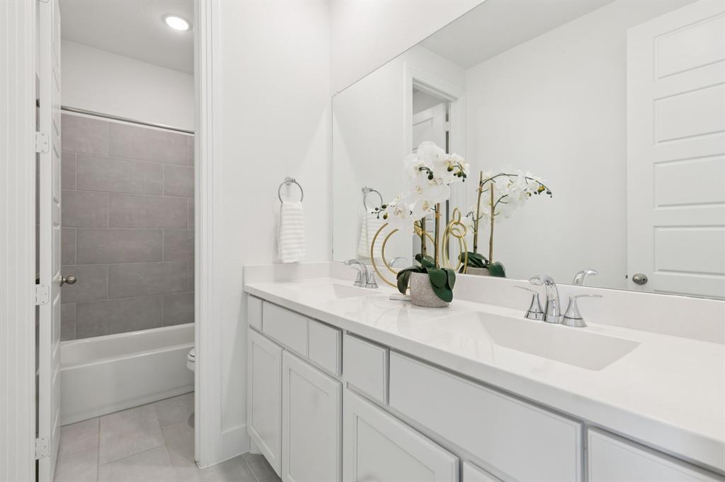 1903 Midhurst Drive Forney, TX 75126 - Photo 21 of 31 a bathroom with a sink and a mirror