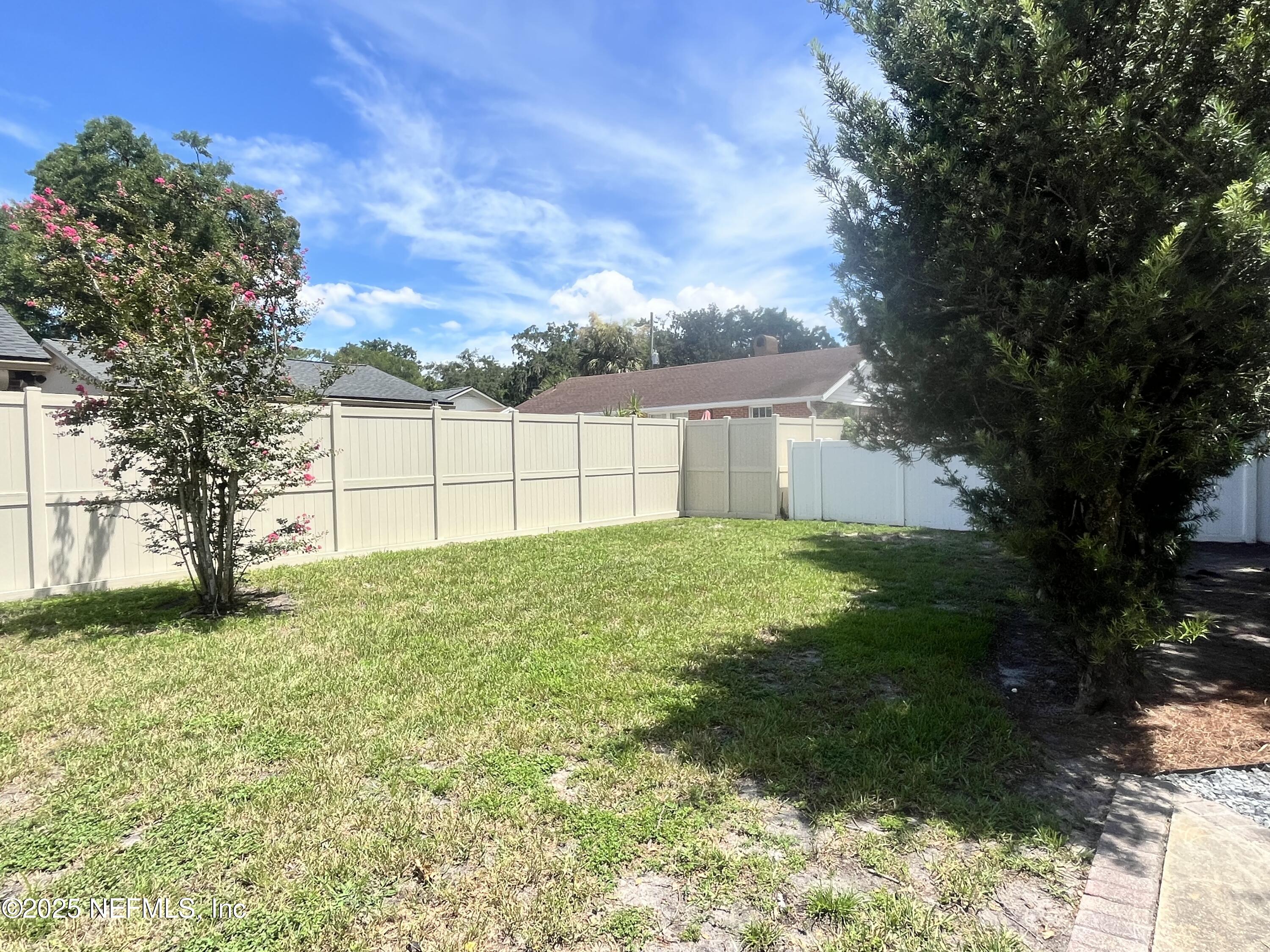 1802 Kingswood Road Jacksonville, FL 32207 - Photo 13 of 13 a backyard of a house with plants and large trees
