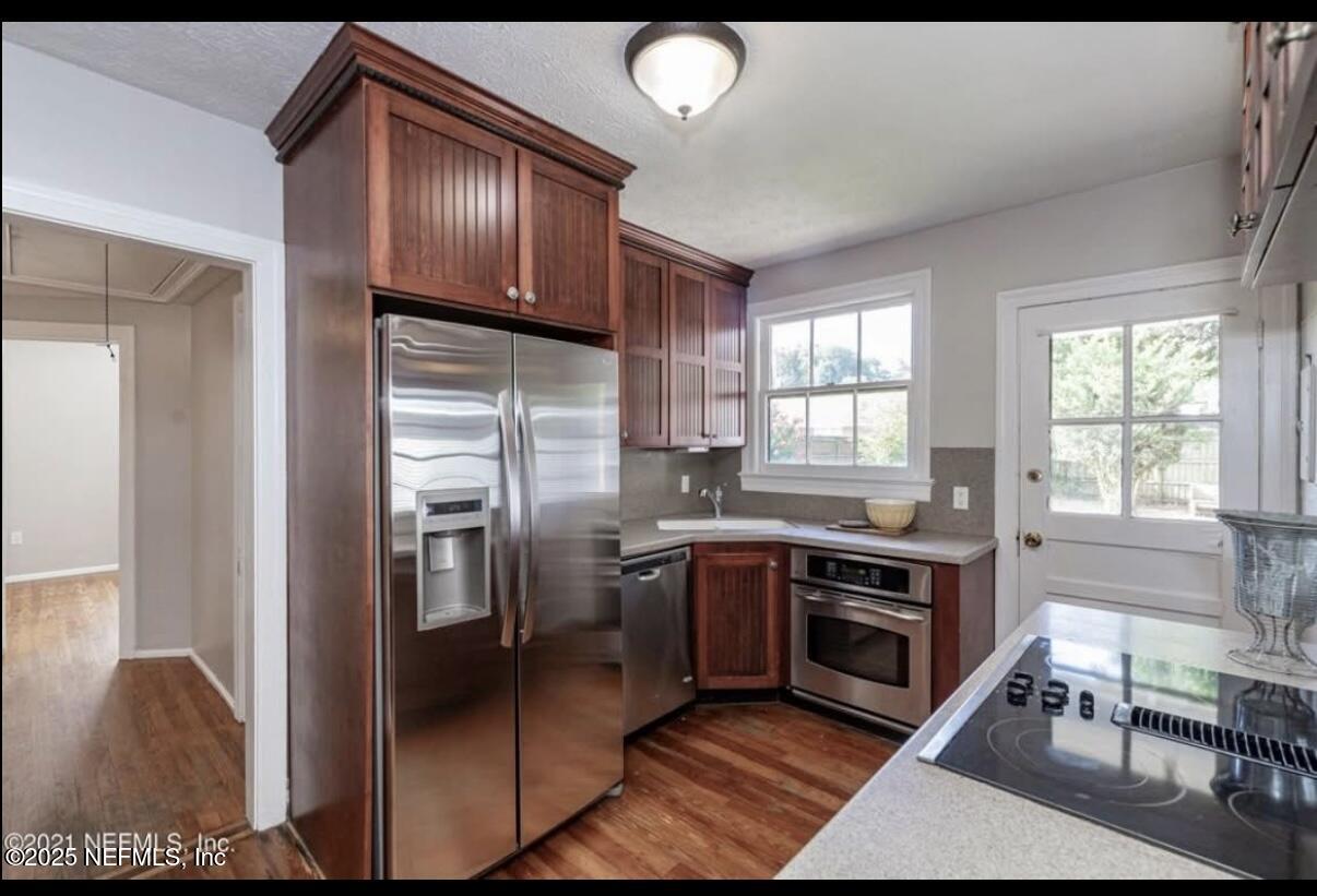 1802 Kingswood Road Jacksonville, FL 32207 - Photo 3 of 13 a kitchen with stainless steel appliances granite countertop a stove a sink and a refrigerator