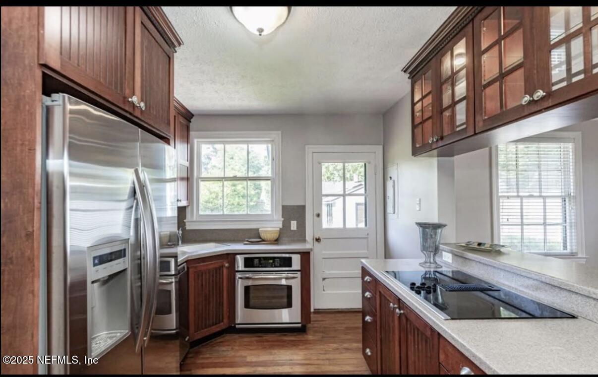 1802 Kingswood Road Jacksonville, FL 32207 - Photo 4 of 13 a kitchen that has a sink a stove and a refrigerator