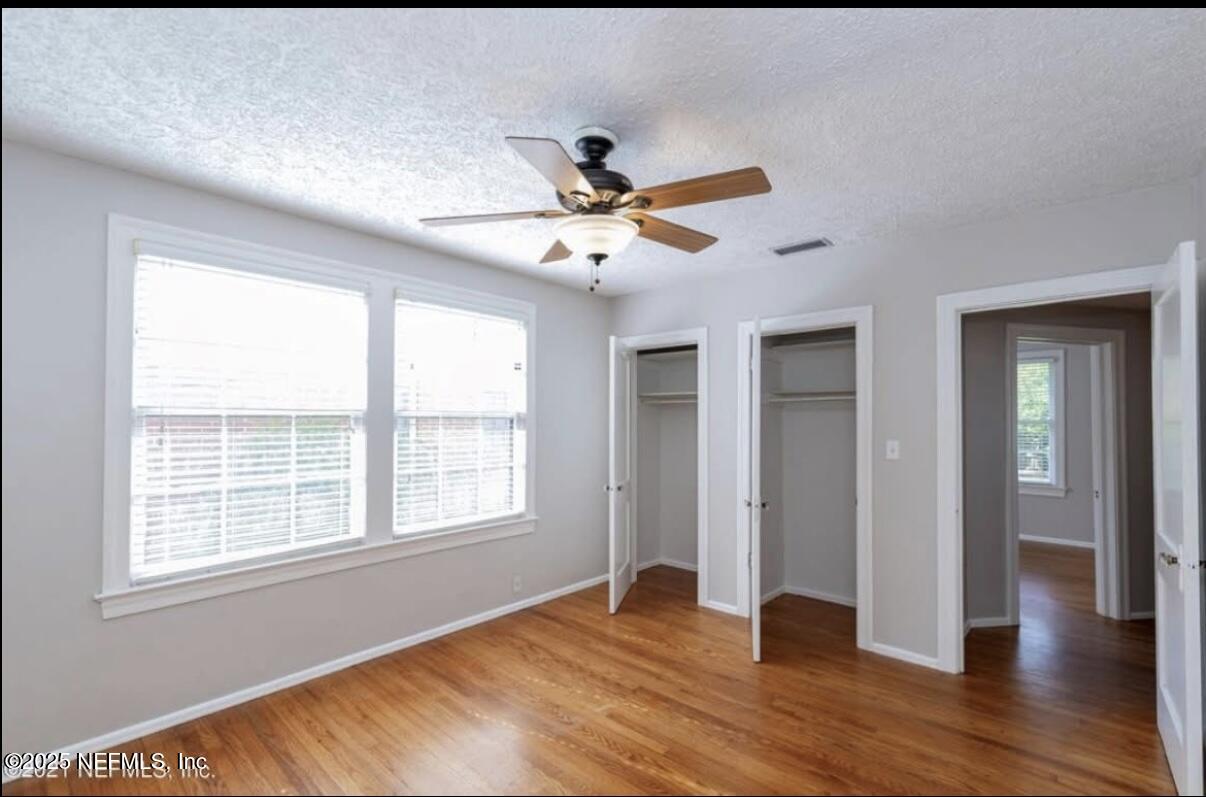 1802 Kingswood Road Jacksonville, FL 32207 - Photo 5 of 13 a view of an empty room with window and wooden floor