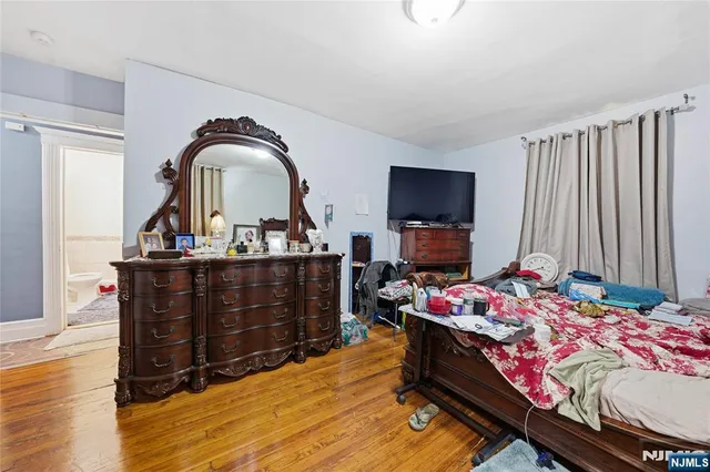 a bedroom with furniture and flat screen tv
