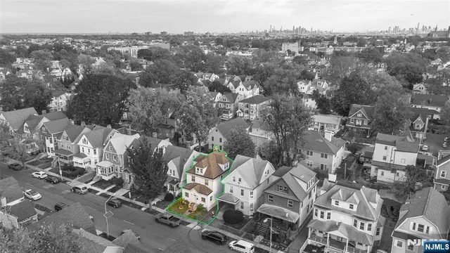 an aerial view of residential houses with outdoor space and swimming pool
