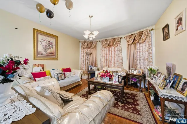 a living room with furniture and a chandelier