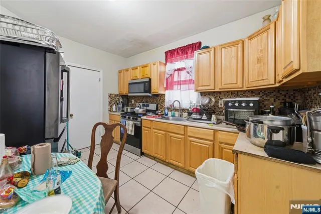 a kitchen with stainless steel appliances a sink and a refrigerator