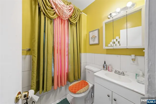 a bathroom with a sink a toilet and a mirror