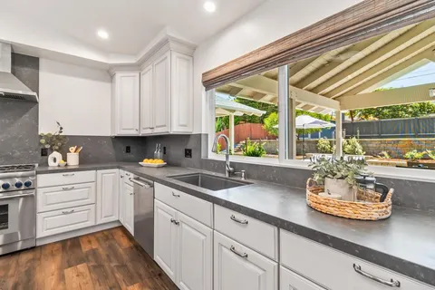 a kitchen with a sink and white cabinets