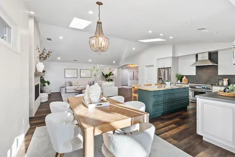 a large kitchen with a table and chairs in it