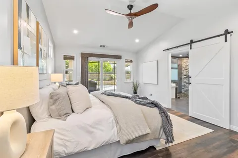 a bedroom with a bed couch and a window