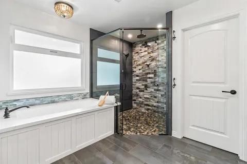a bathroom with a bathtub and a shower
