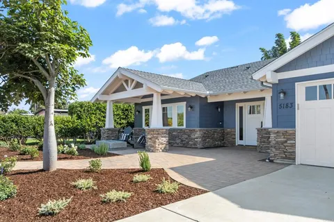 a front view of a house with a yard outdoor seating and barbeque oven