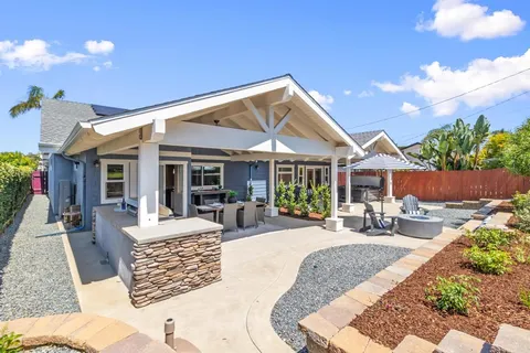 a view of a house with sitting area and garden