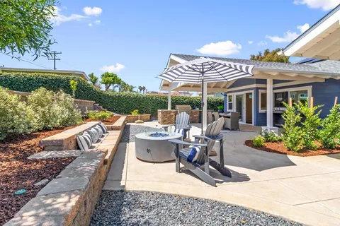 a view of a patio with couches chairs and a potted plant