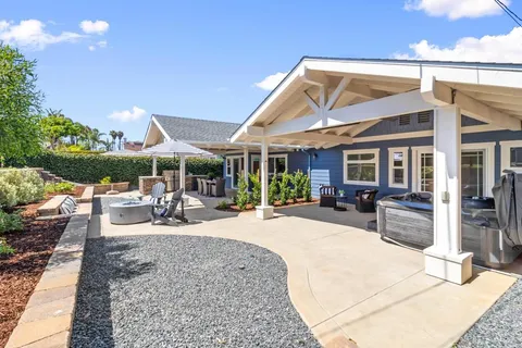 a view of a house with backyard porch and sitting area
