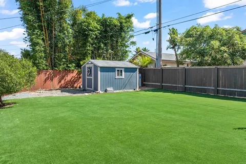 a view of a house with a backyard and a garden