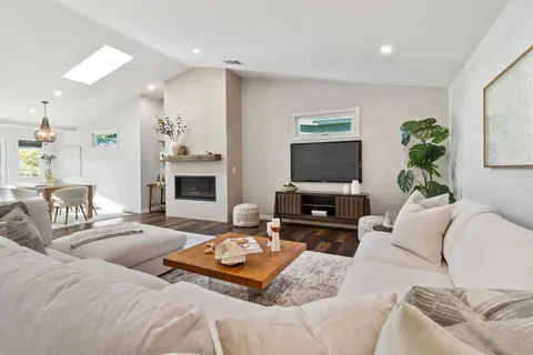 a living room with furniture a fireplace and a flat screen tv