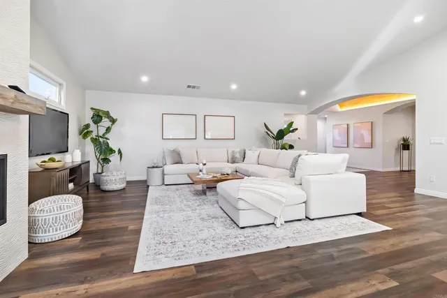 a living room with furniture potted plant and a table